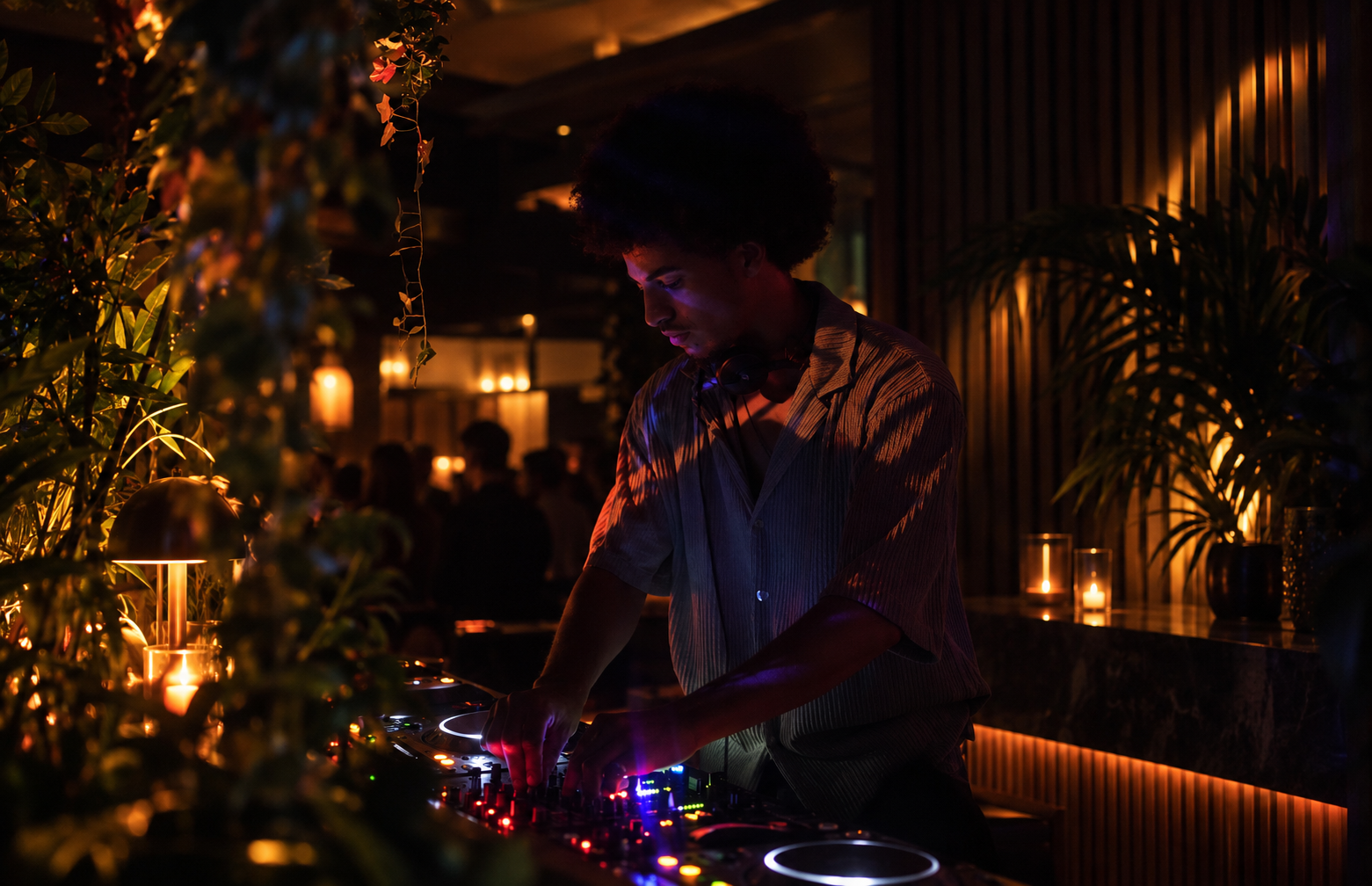 ATMOZ’s founder DJing in a warmly lit venue